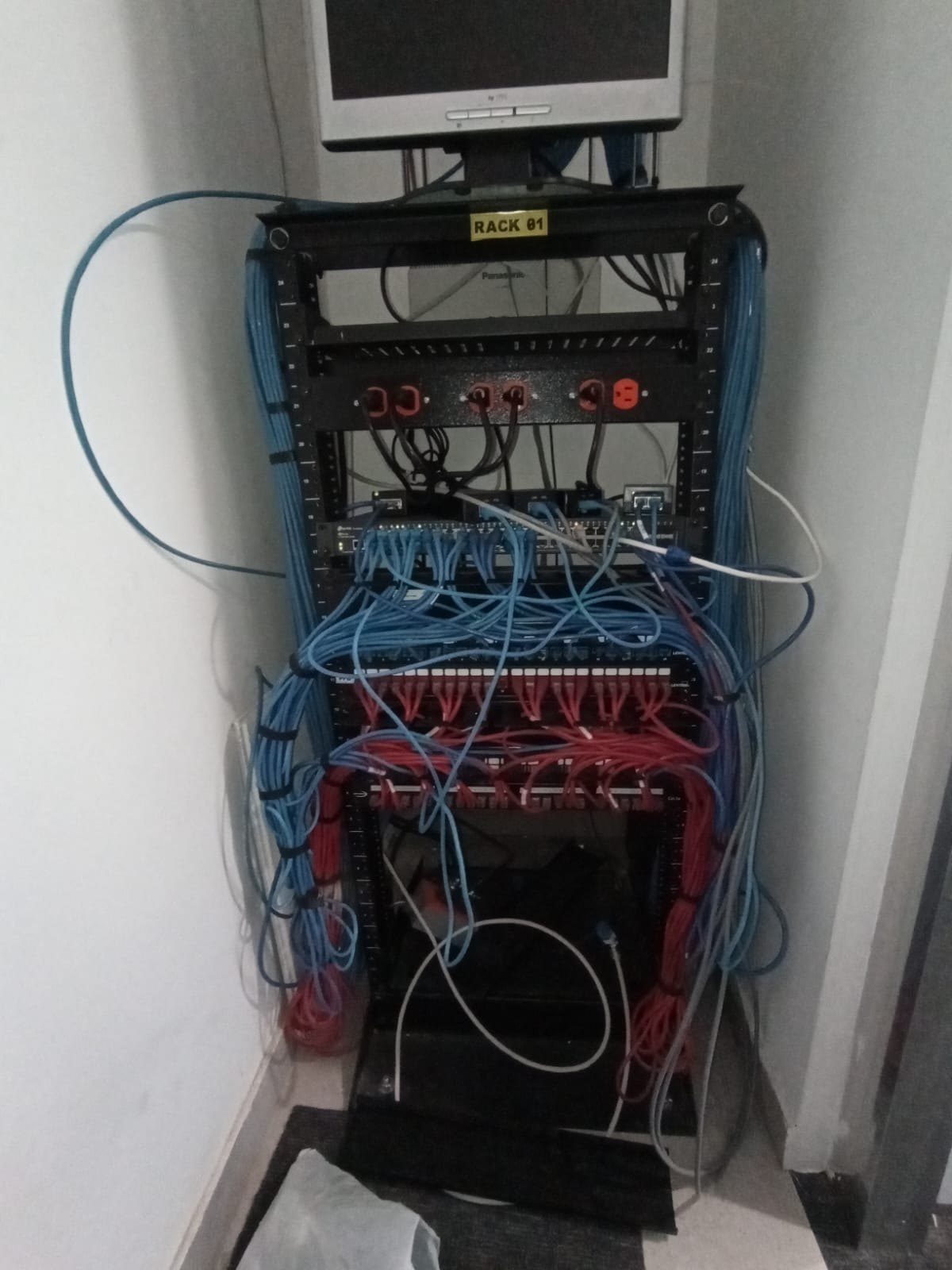 Network rack with tangled cabling before our work